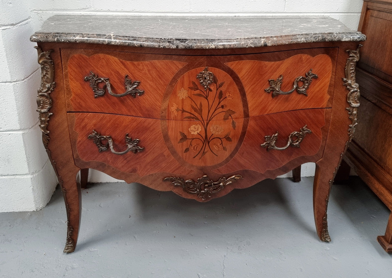 Beautiful French walnut Louis XV style two drawer commode. With a lovely floral marquetry inlaid design and marble top. It is in good original detailed condition.