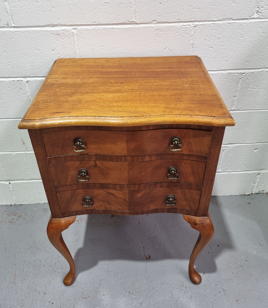 Antique Queen Anne style figured Walnut Bedside cabinet with 3 drawers. It is in good original detailed condition.