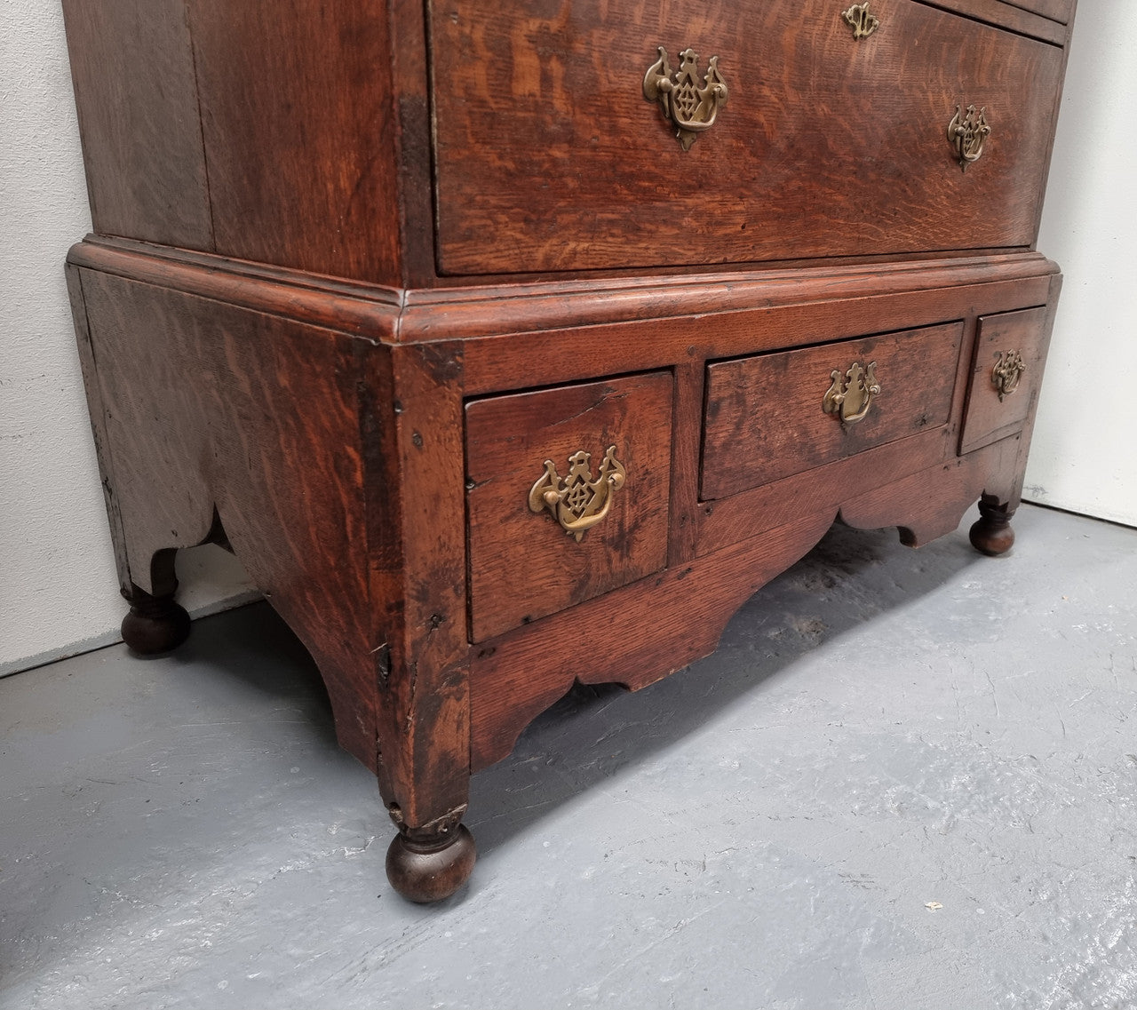 Early 19th Century English Oak chest on stand. It has been sourced in France and has plenty of storage space with eight drawers. In good original detailed condition.
