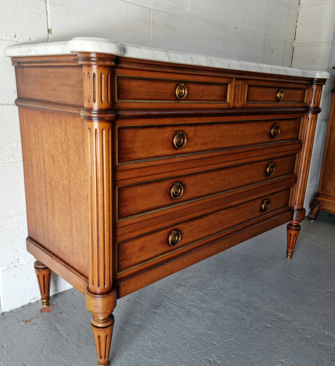 Beautiful French Louis XV Style Marble top five drawer commode. There are five drawers and it has a lovely brass inlay. It is in good original detailed condition.