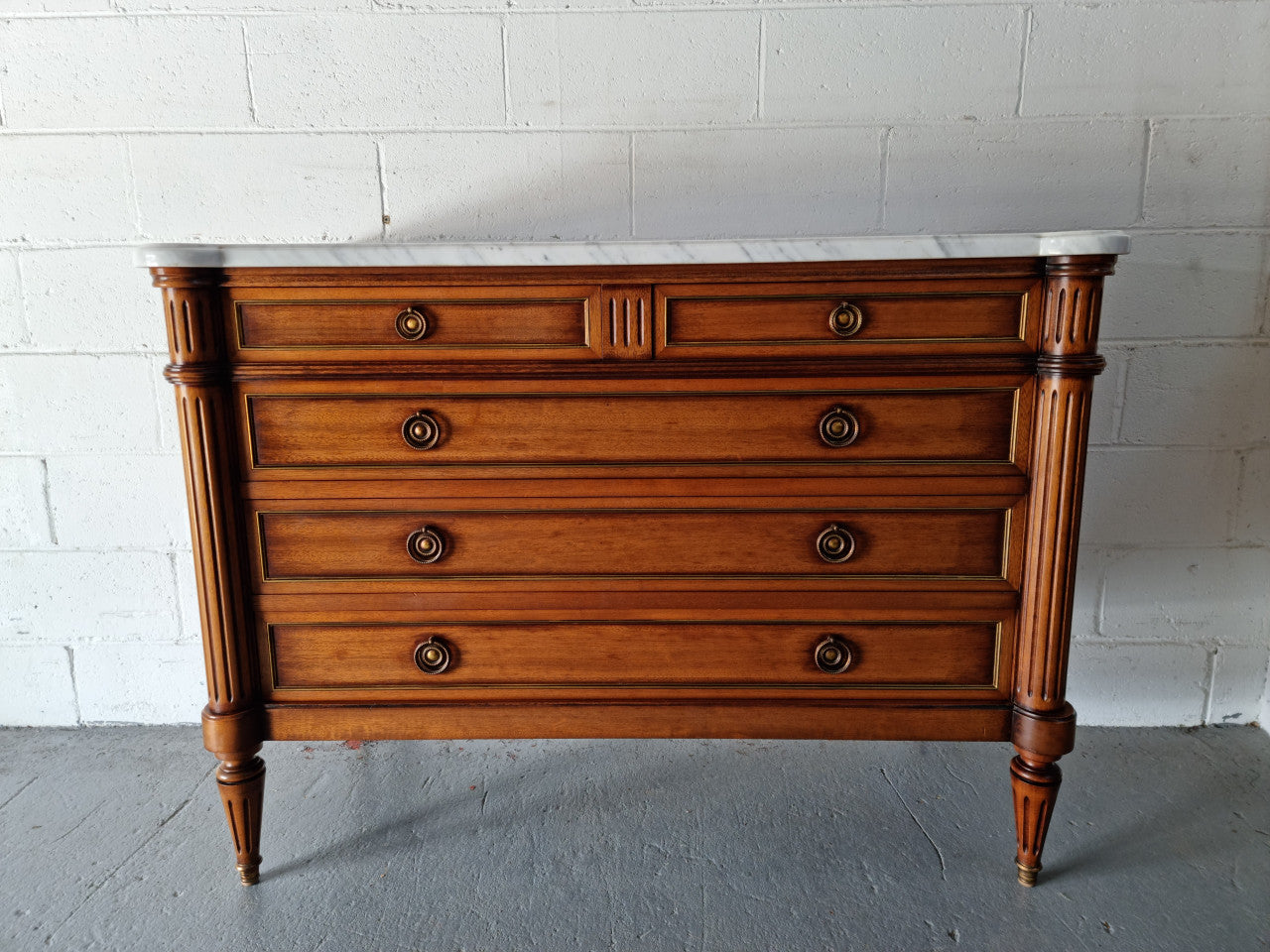 Beautiful French Louis XV Style Marble top five drawer commode. There are five drawers and it has a lovely brass inlay. It is in good original detailed condition.