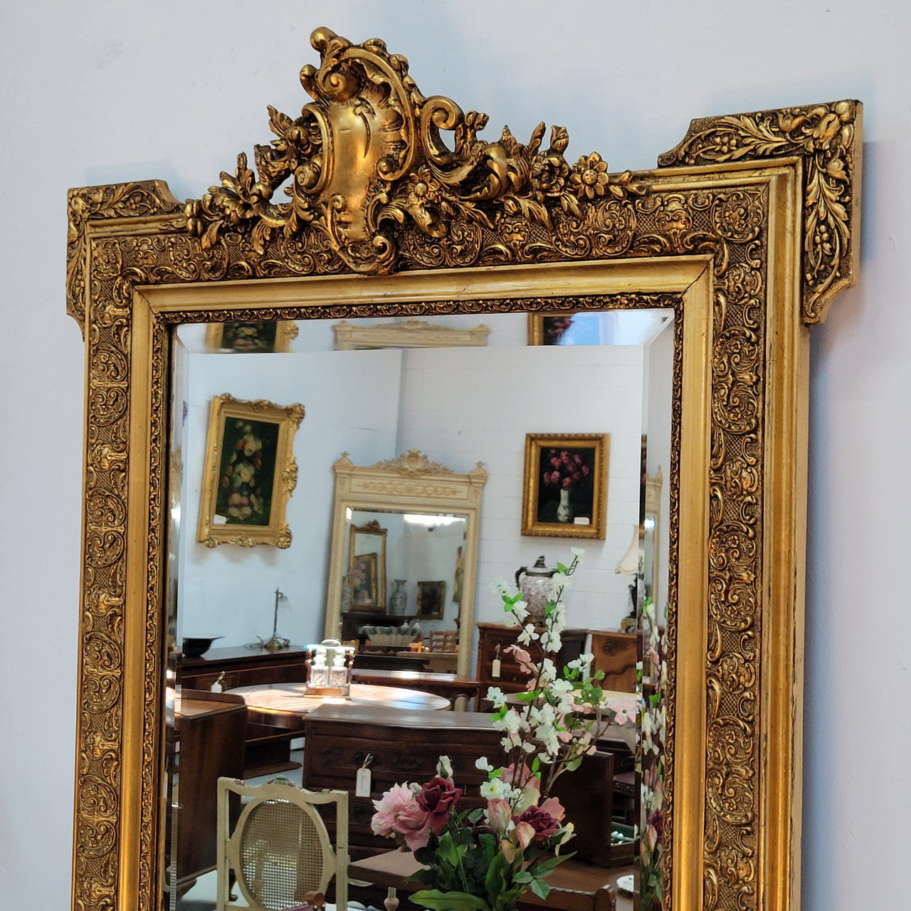 French 19th Century gilt over mantle mirror with beveled glass. In good original detailed condition.