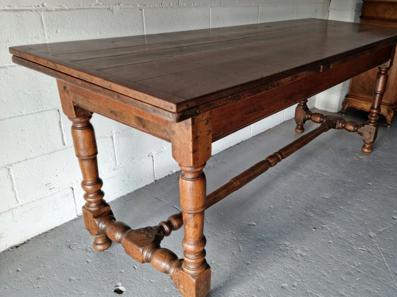 Appealing and rare French Oak Farmhouse extension table. Charming character to the top and comfortably seats 12 people. In good original detailed condition.