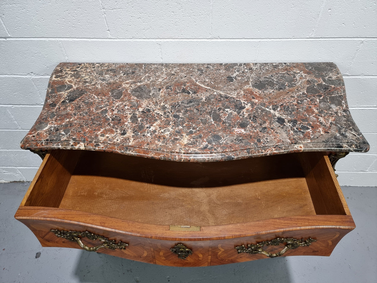 Attractive French marble top Louis XV style three drawer commode with decorative ormolu mounts. In good original detailed condition.