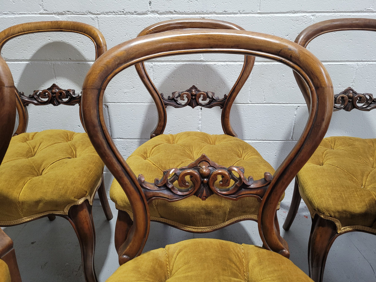 Set of six upholstered Victorian balloon back chairs. In good original detailed condition.