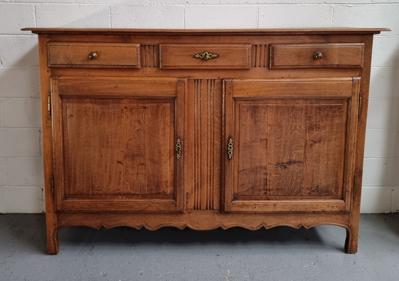 French Oak Early 19th Century sideboard with two doors and three drawers. In good original condition.