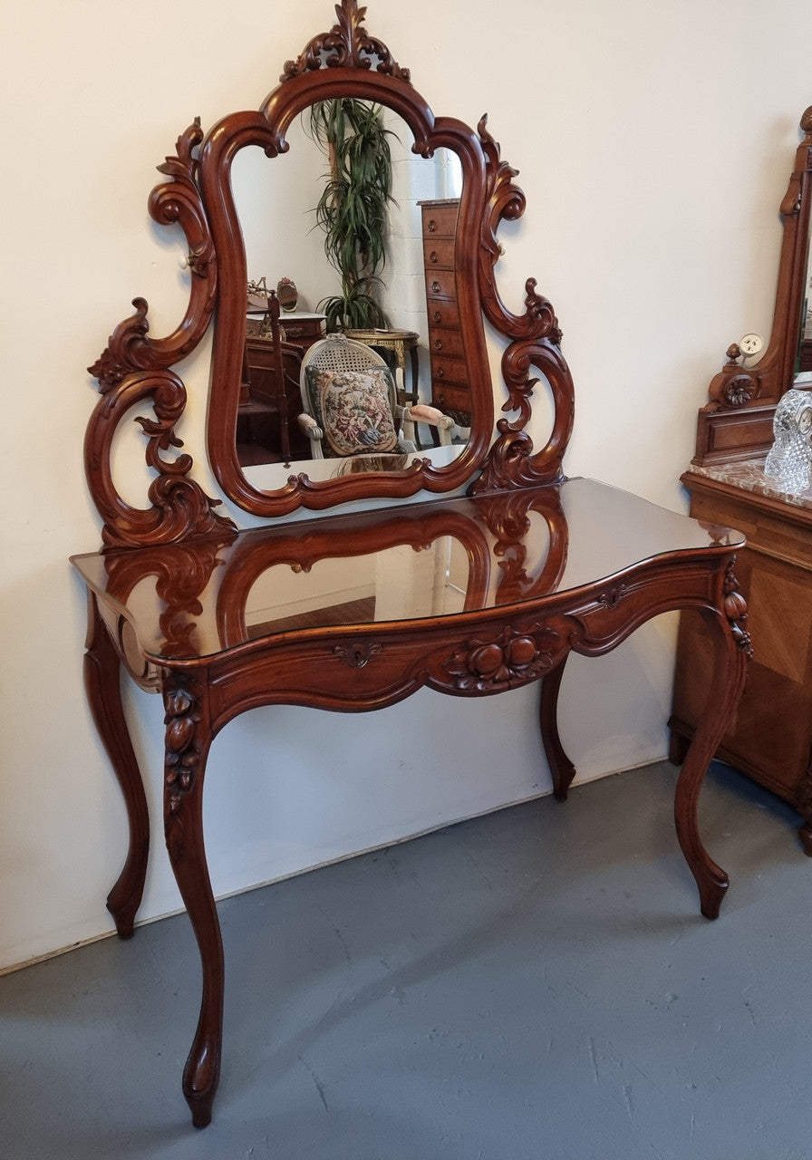 Walnut Parisian late 19th Century dressing table with mirror. Also has a glass top for protection, mirror moves and has drawers with key and working locks. In good original detailed condition.