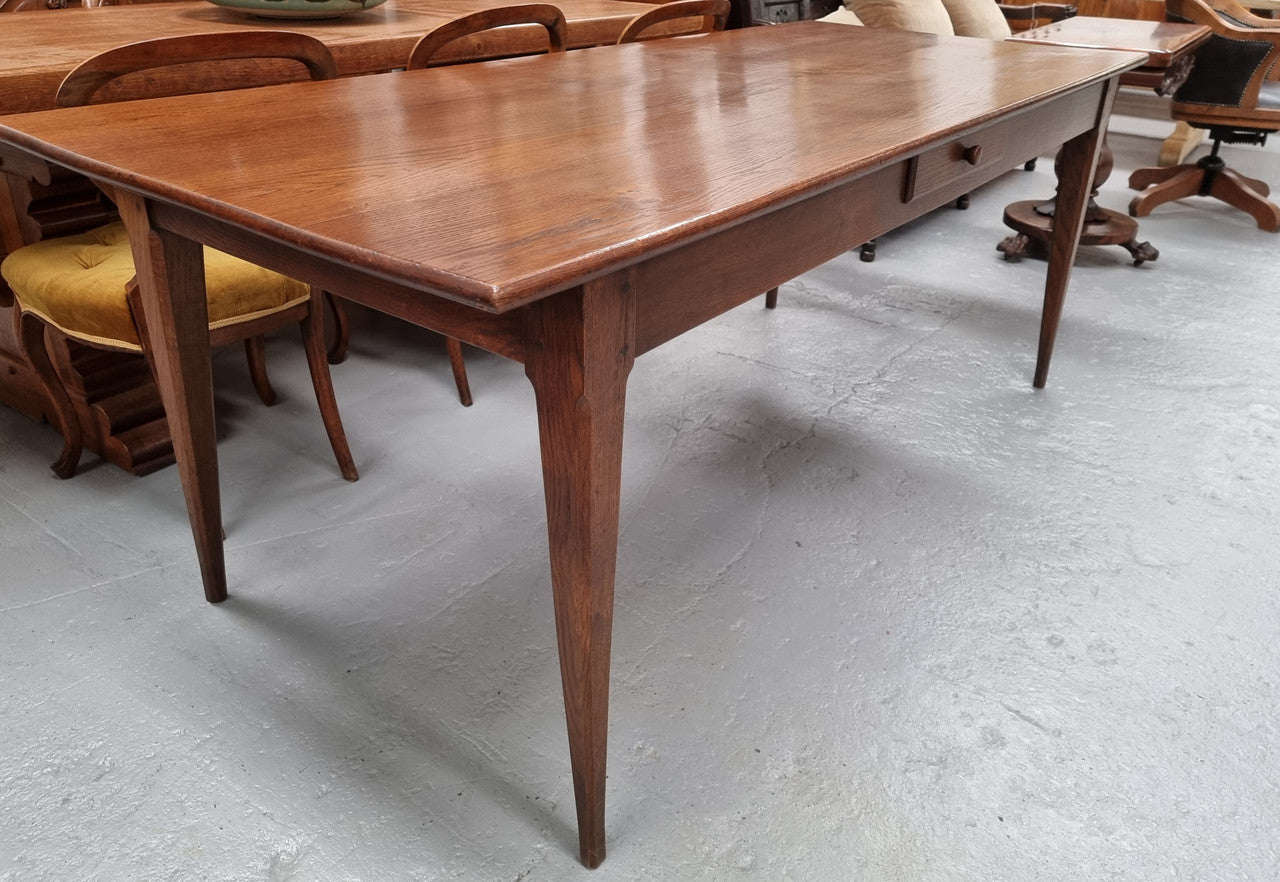 Antique French Oak Farmhouse table in fully restored condition. Features a single drawer and tapered legs.