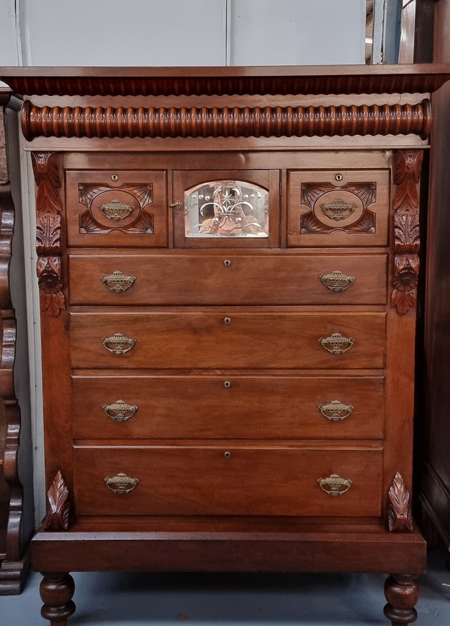 A 19th Century Scottish Mahogany tall boy/ chest of six drawers with small cabinet section at the top. Beautiful carvings and easily comes apart into three sections making transport for moving into place easy. In good original detailed condition.
