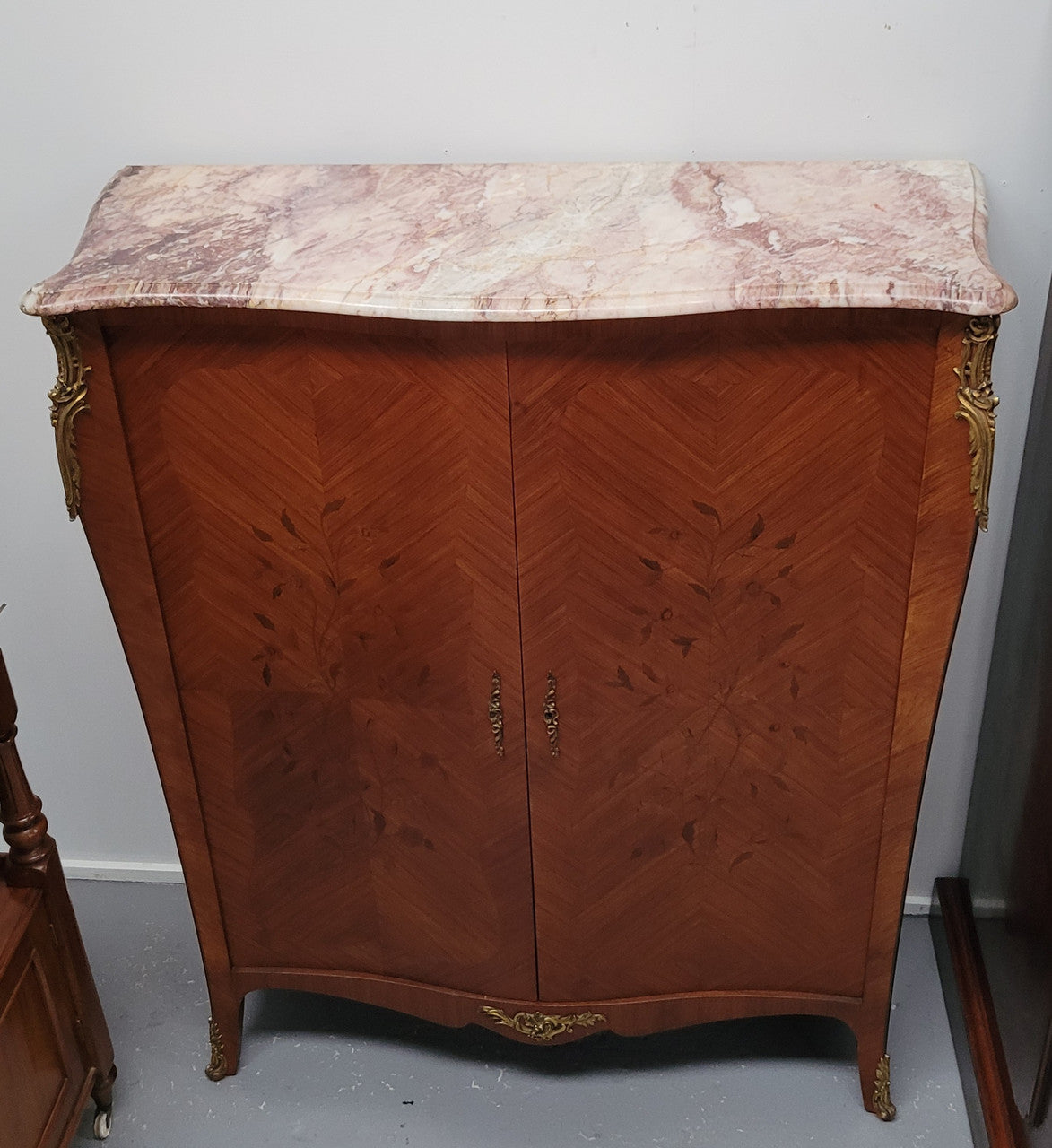 French Louis 15th style Kingwood marquetry inlaid two door cupboard with a beautiful marble top. It has three adjustable shelves and decorative ormolu trim. It has been sourced from France and is in good original detailed condition.