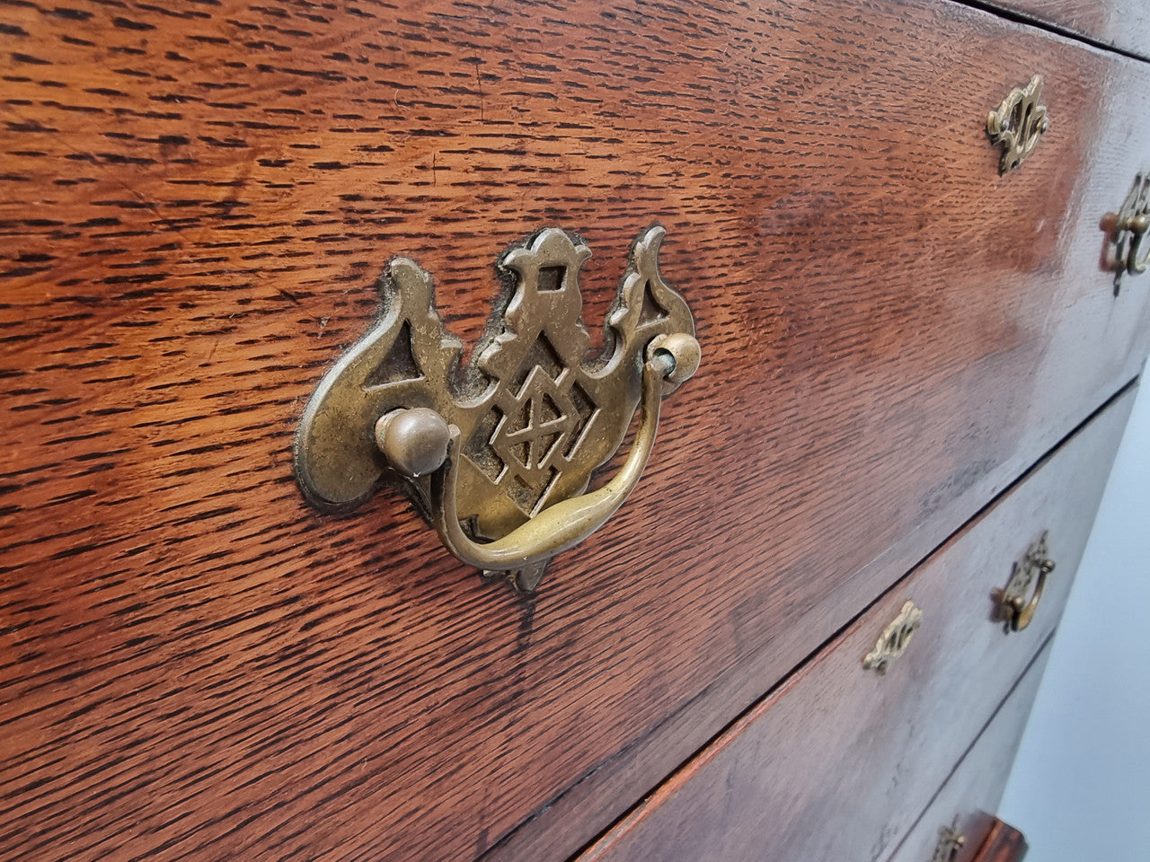 Early 19th Century English Oak chest on stand. It has been sourced in France and has plenty of storage space with eight drawers. In good original detailed condition.