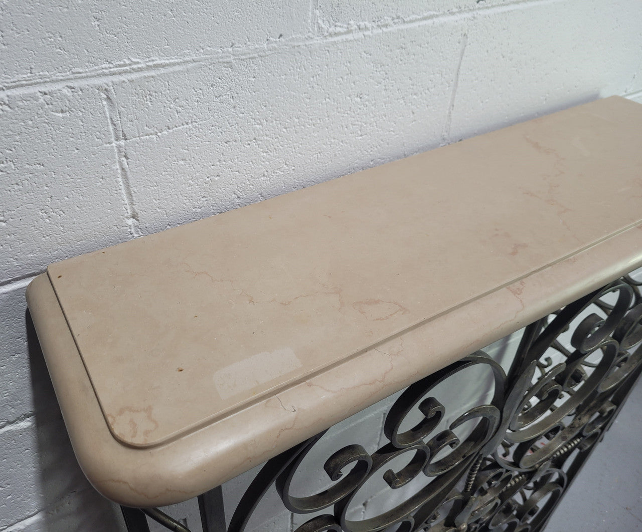 Stunning Art Deco wrought iron and marble top console table. It has amazing decorative iron work at the bottom and a beautiful marble top. It is in good original detailed condition.