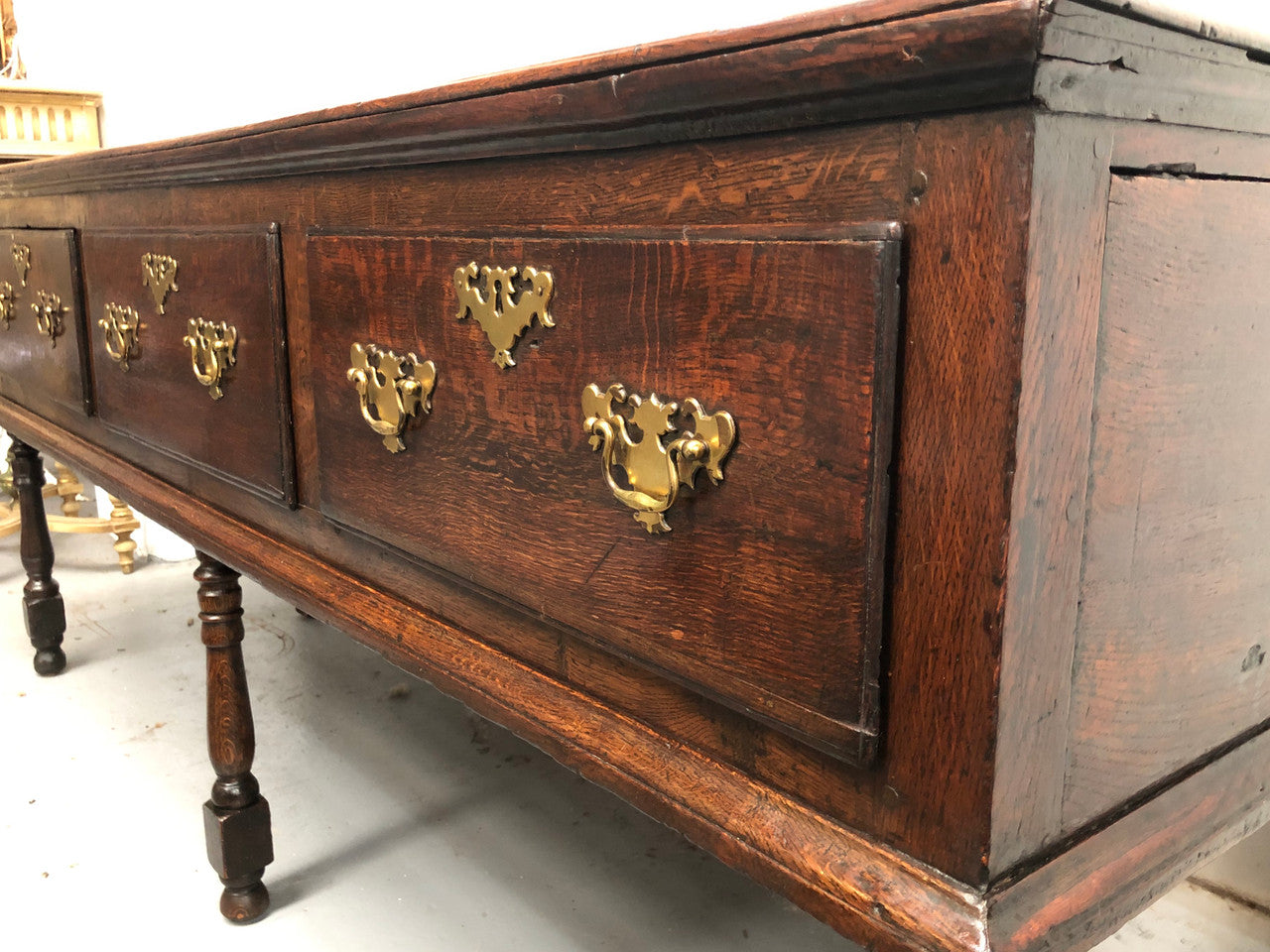 Early 19th Century English Oak dresser base with three large drawers. In very good original detailed condition.