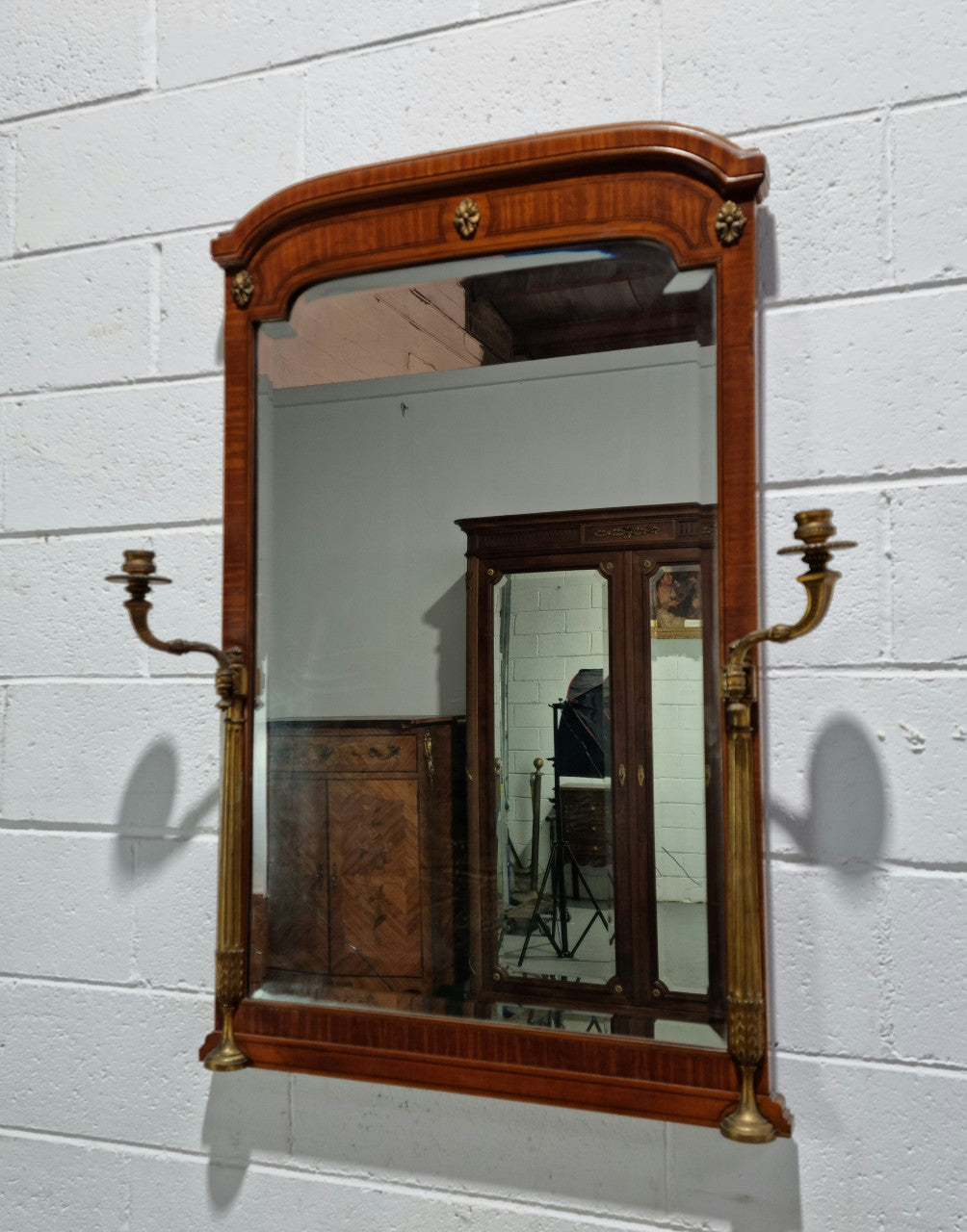 Decorative late 19th Century mahogany French wall mirror with brass swivel candle holders and brass detail. In good original detailed condition.