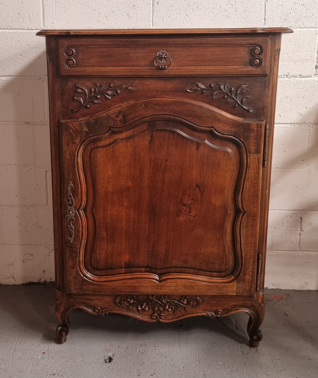 Louis 15th style walnut cupboard consisting of one drawer and two shelves. A pleasing unit with charming carvings. Circa: 1920's. In good original detailed condition.