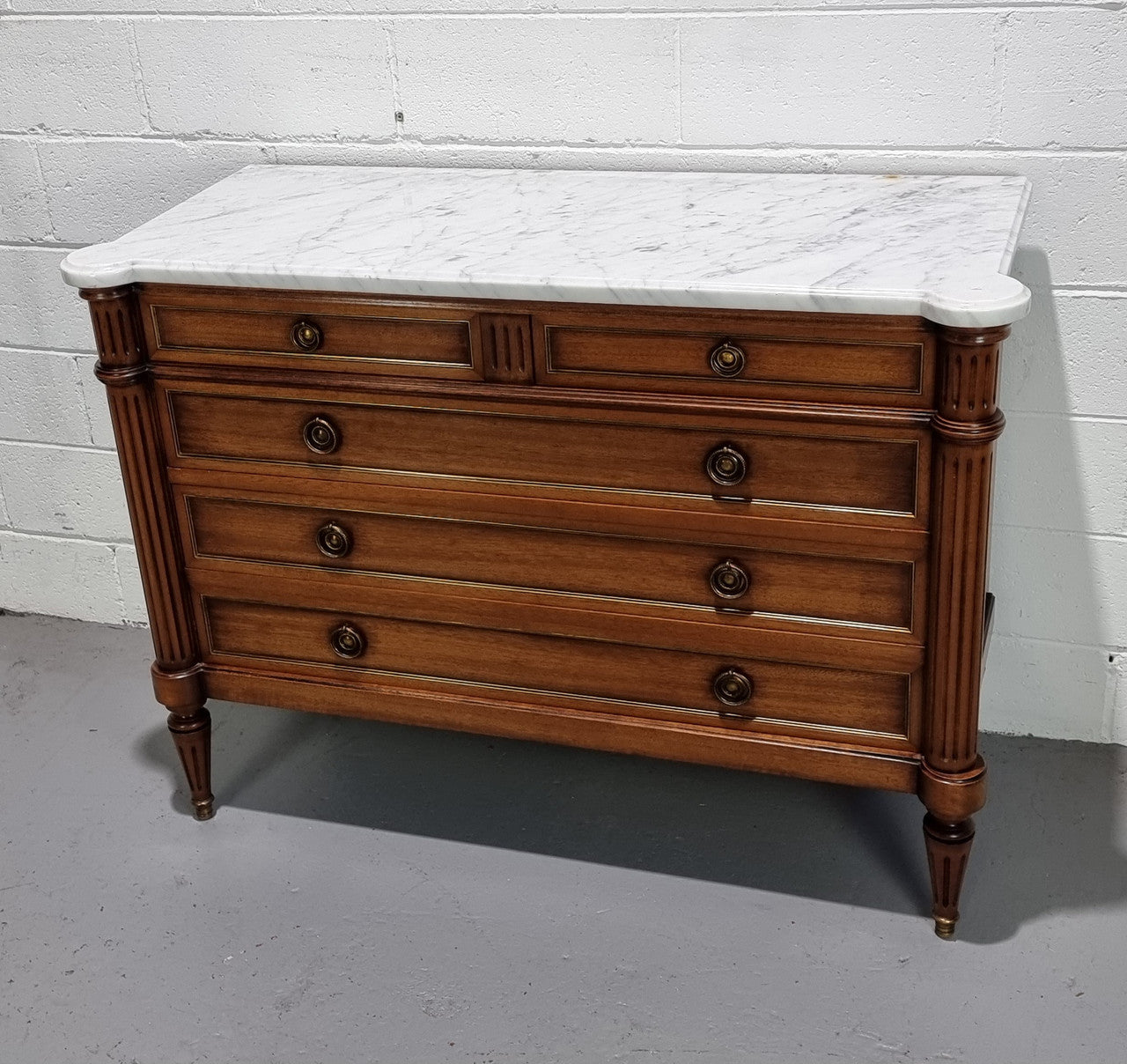 Beautiful French Louis XV Style Marble top five drawer commode. There are five drawers and it has a lovely brass inlay. It is in good original detailed condition.