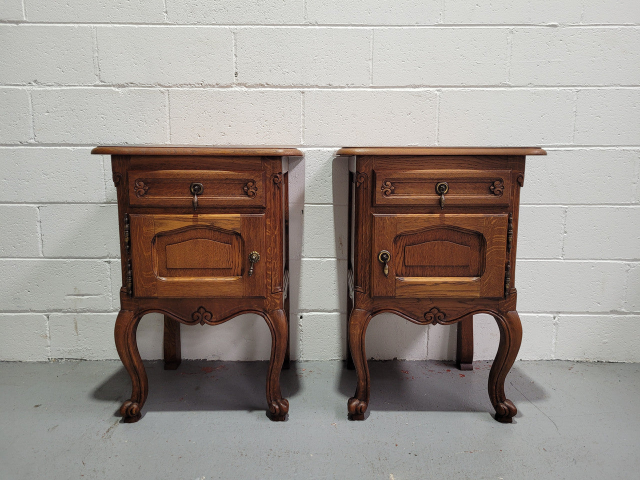 Pair of low Louis XV Style Oak bedsides with hard to find wooden tops. They are in good original detailed condition.