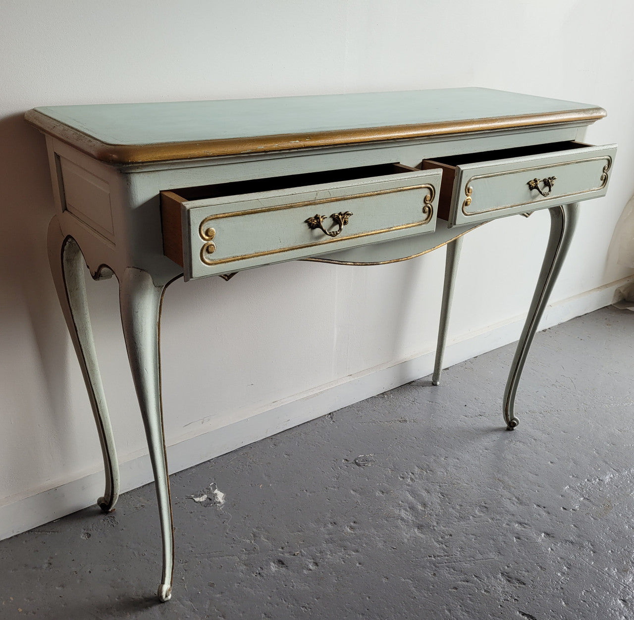 Vintage French Louis 15th style original painted and gilded highlights two drawer console table. It has been sourced from France and is in good original condition.