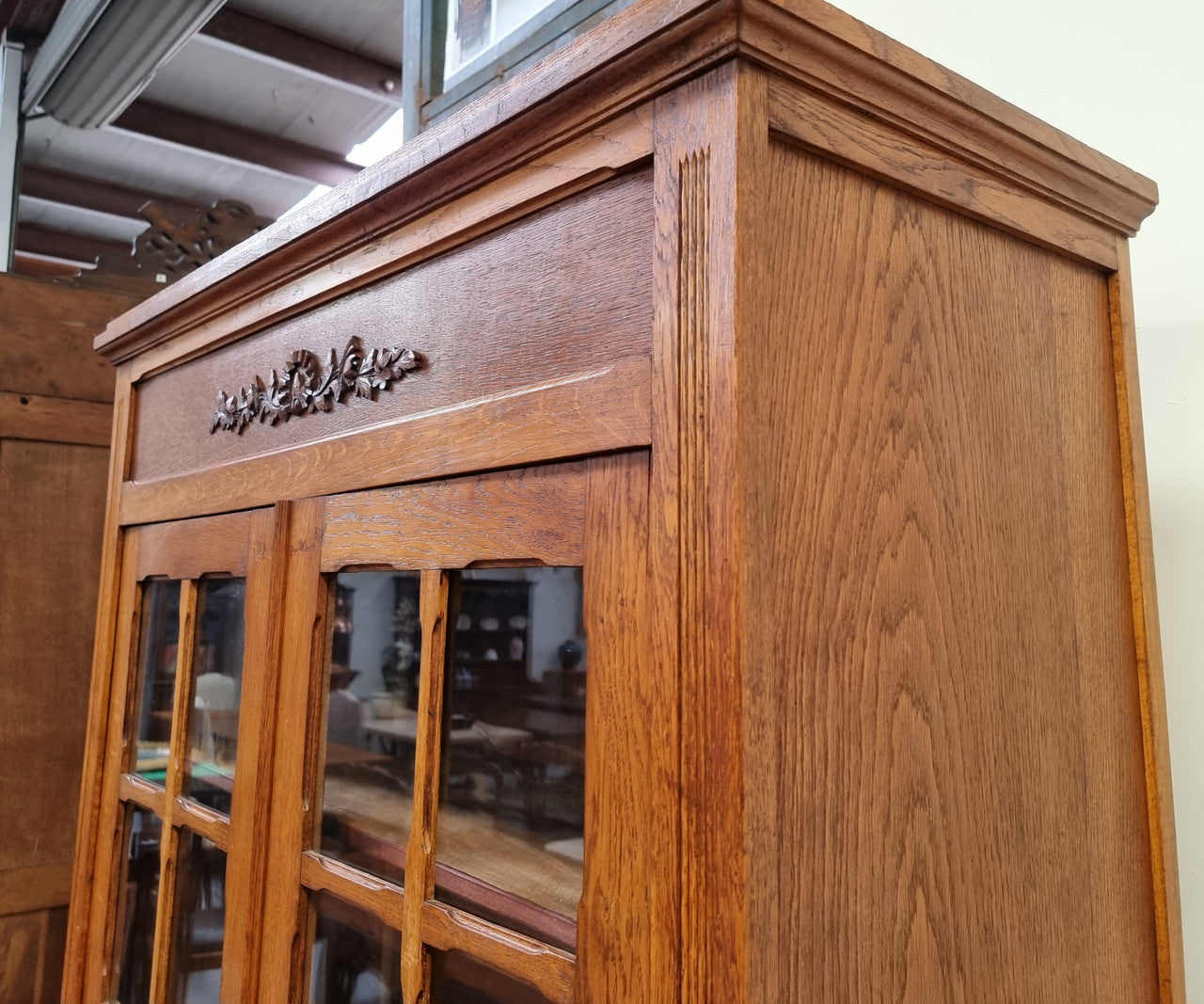 French light Oak two door bookcase with four adjustable shelves. It has beautiful decorative carving and is in good original detailed condition.