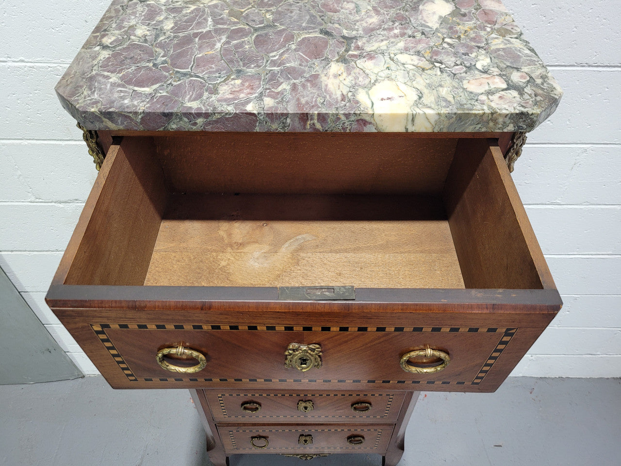 Louis XIV style tall chest of five drawers with stunning marble top. It is of small proportions and has very nice mounts and handles. In good original detailed condition.