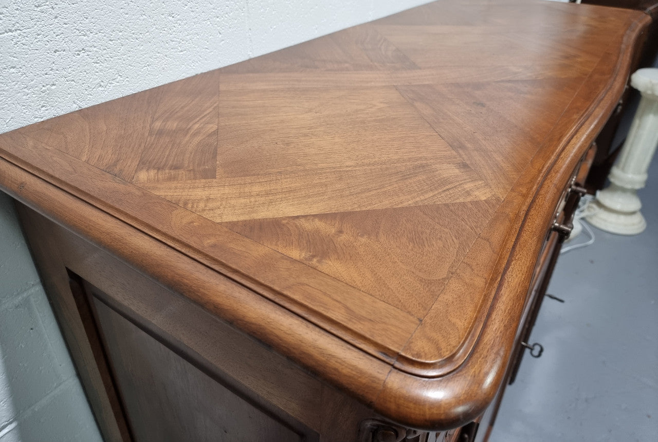 French Walnut two door buffet with parquetry top. It has two drawers and an adjustable shelf. In good original detailed condition and it has been sourced from France.