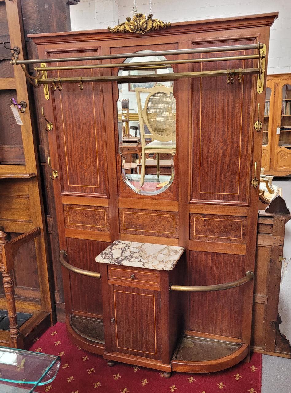 Attractive French Burr Walnut Hallstand. It has a single drawer, cupboard, brass rods, umbrella storage and a marble shelf. It is in good original condition. Please see photos as they form part of the description.