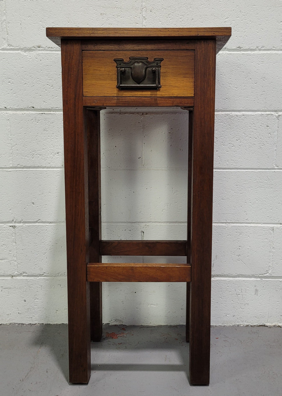 Small Arts and Crafts side table/bedside table. With drawer and is in good original detailed condition.