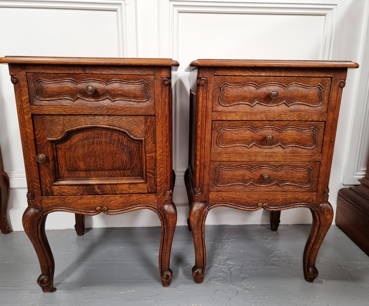 Pair of French provincial Oak bedsides. They have attractive cravings and there is one with three drawers and other one has a cupboard and a drawer. They have been sourced from France and are in good original detailed condition.