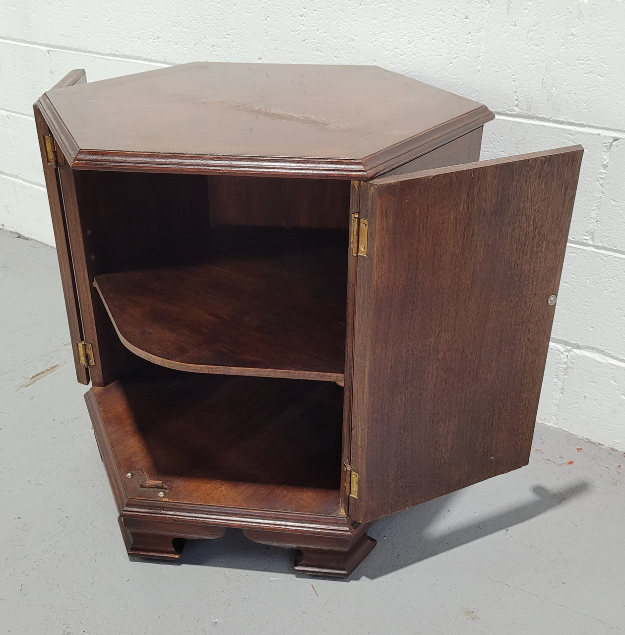 Hexagonal Mahogany enclosed side cabinet with two doors. Would make an ideal side cabinet and is in good restored condition.