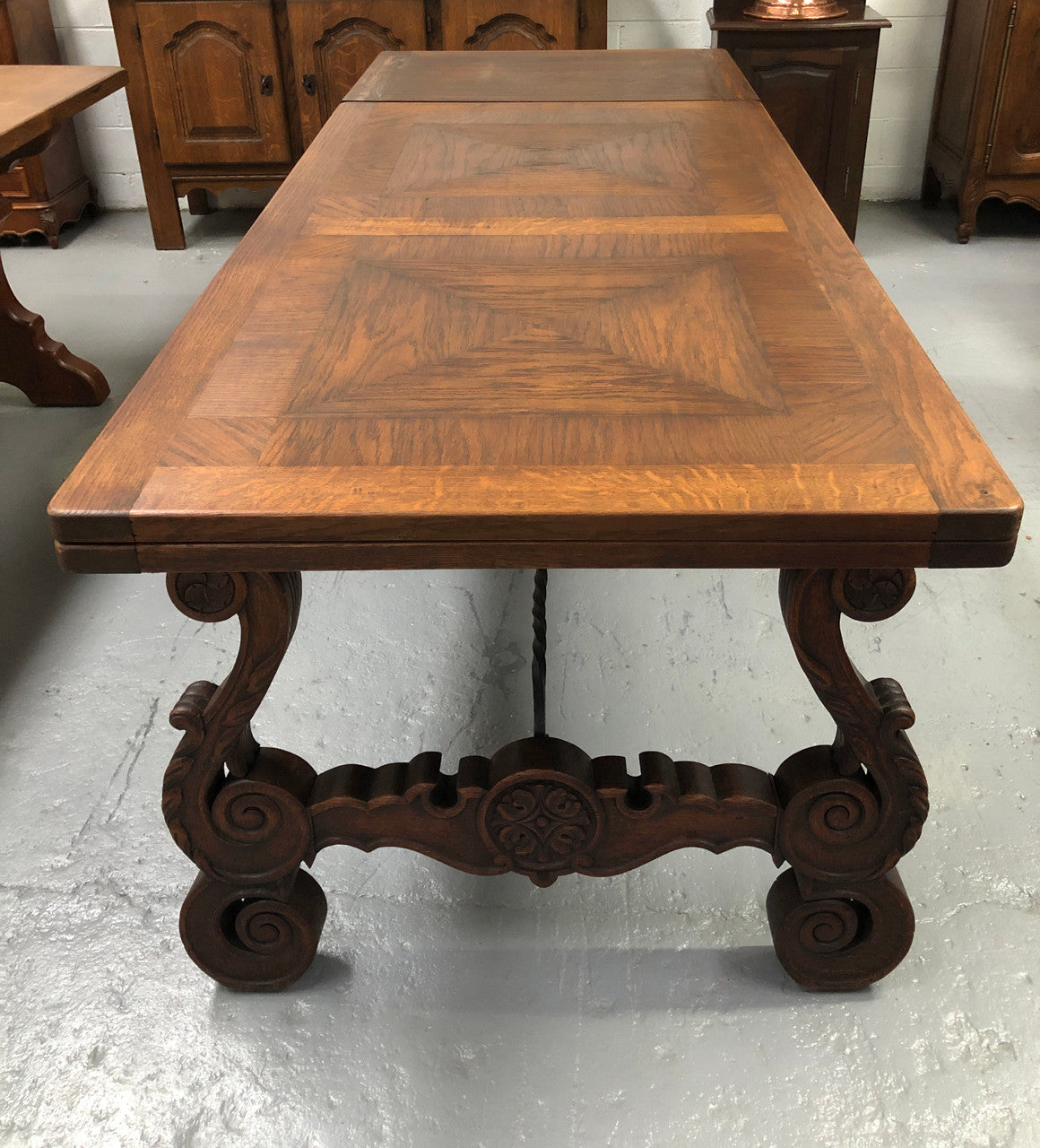 French Oak Renaissance style extension table with a lovely parquetry top and decorative carved and iron base in good original detailed condition.