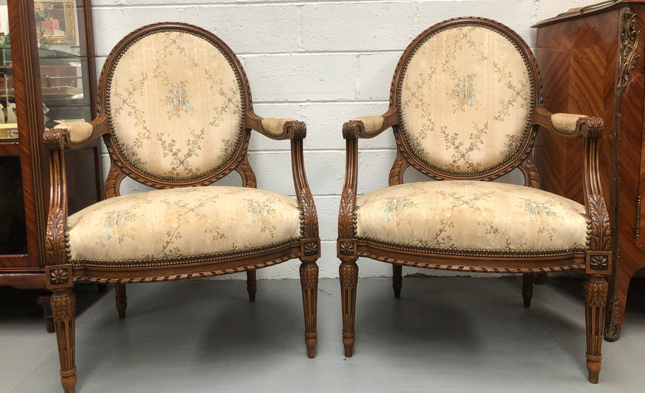 Pair of Antique French Louis XVI style carved Walnut fauteuils in restored condition. The Tapestry upholstery is in good condition some marks and wear but usable.