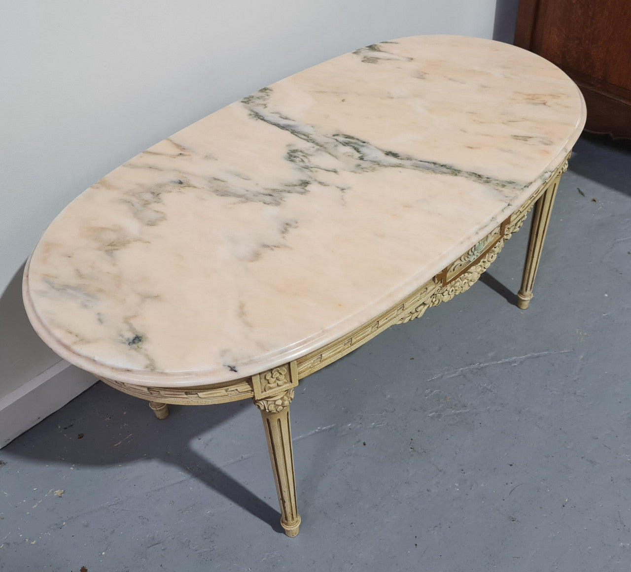Charming painted Louis XVI style oval marble top coffee table. In good original detailed condition.