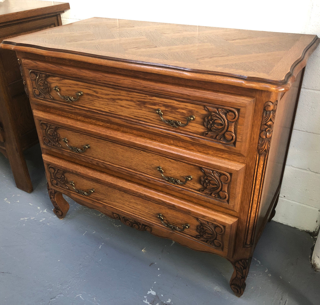 Gorgeous Provincial oak and parquetry top commode. It has beautiful carved Details and in good original detailed condition.