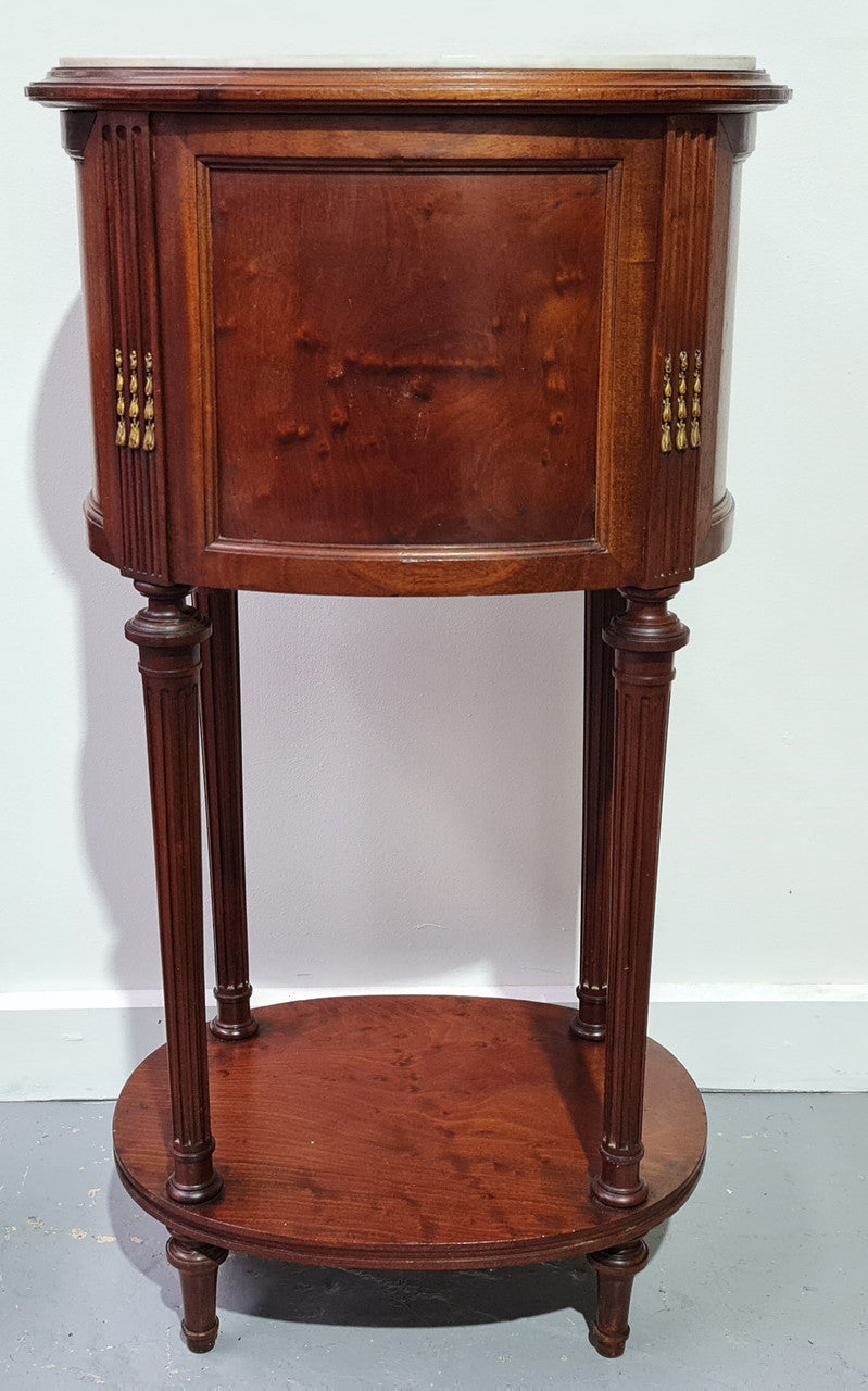 Round Louis XVI style Mahogany marble top side table. It has one drawer and a cupboard for storage. It is in good original detailed condition.