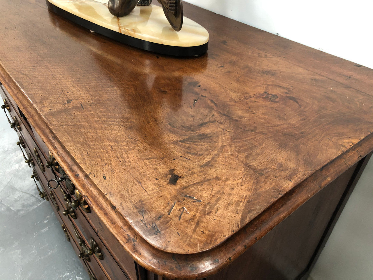 Stunning French 18th Century Walnut commode with beautiful hardware. In good original detailed condition.