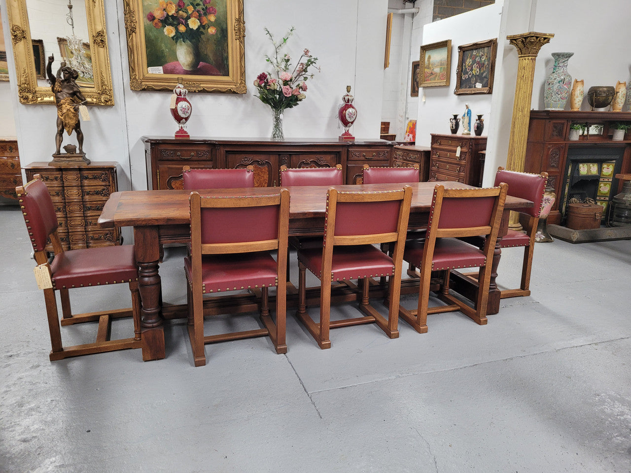 Charming solid rustic Oak stretcher base Farmhouse table. The table is circa 1950's and was custom made using reclaimed oak. It comfortable sits eight and could seat 10. It is in good original detailed condition.