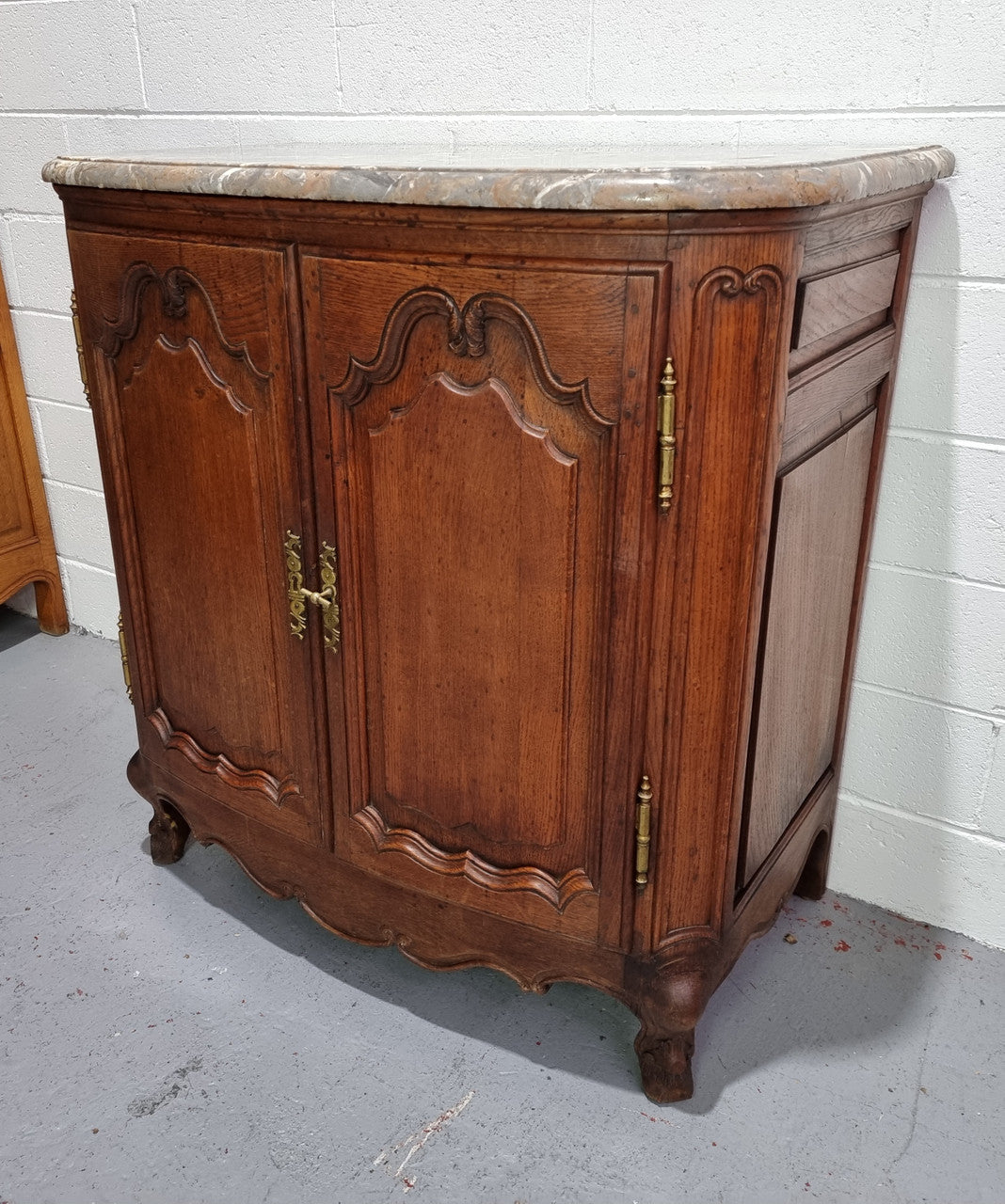 Rare 19th Century French Oak and marble top oval buffet / cabinet. Stunning thick marble top and decorative handles. In good original detailed condition.