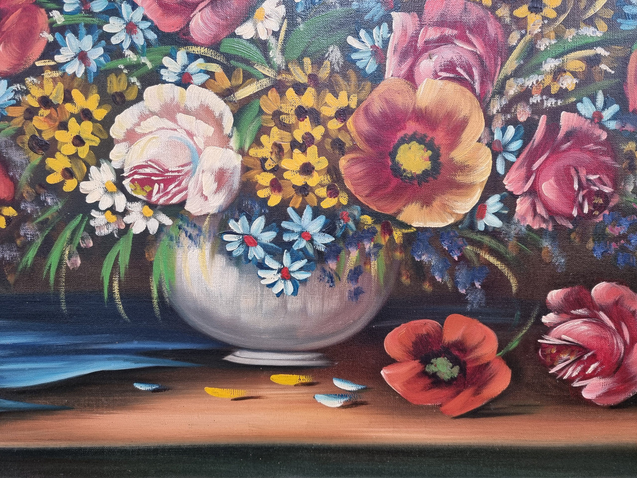 Sourced from France a stunning colorful floral oil painting on canvas. It is in a decorative gilt frame and is signed. It is in good original detailed condition.