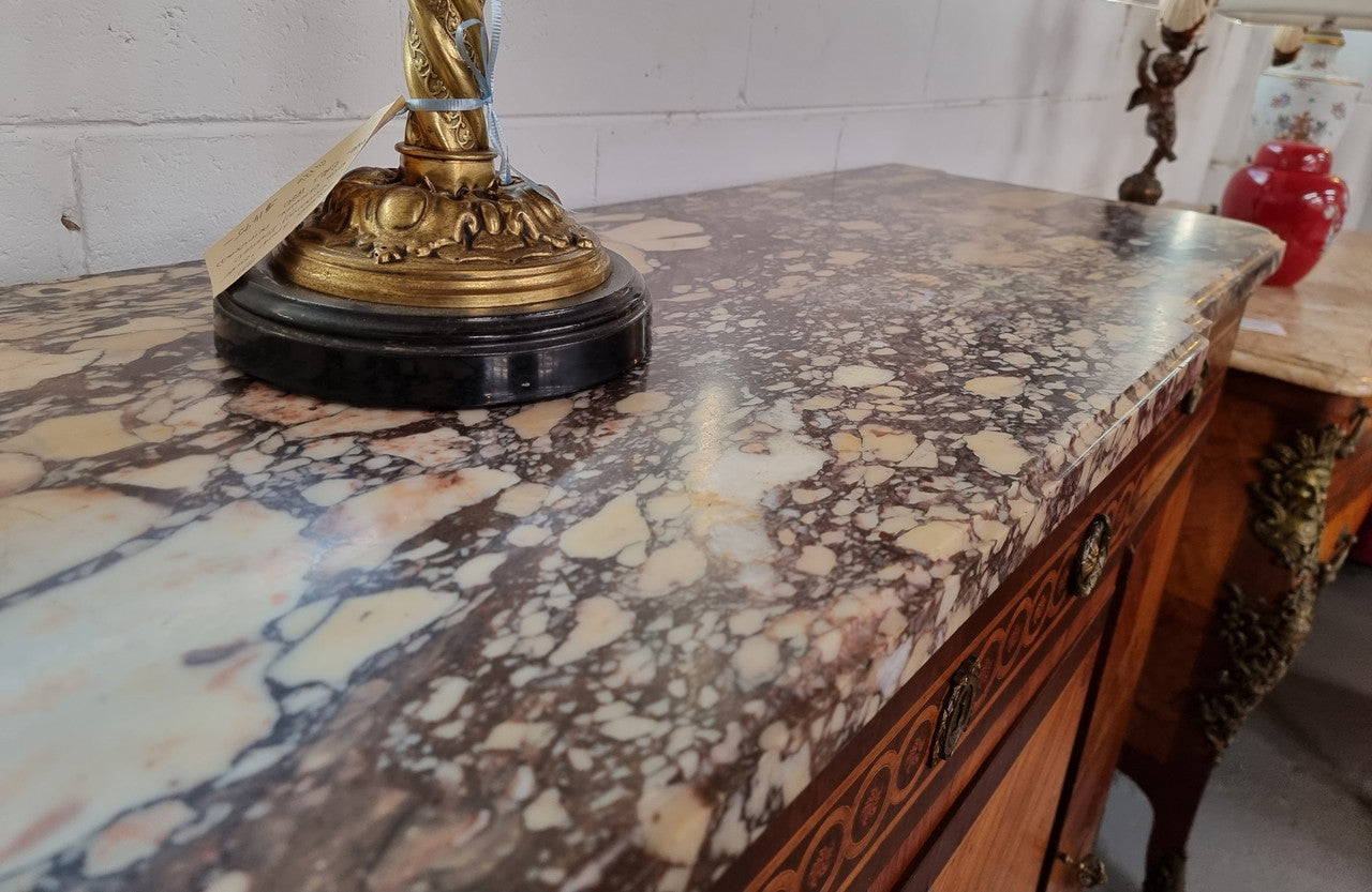 A high quality 19th Century French marquetry inlaid Kingwood marble top credenza. It has an attractive solid marble top and decorative marquetry inlay throughout. It has plenty of storage space with three drawers and three doors. It has been sourced from France and is in good original detailed condition.