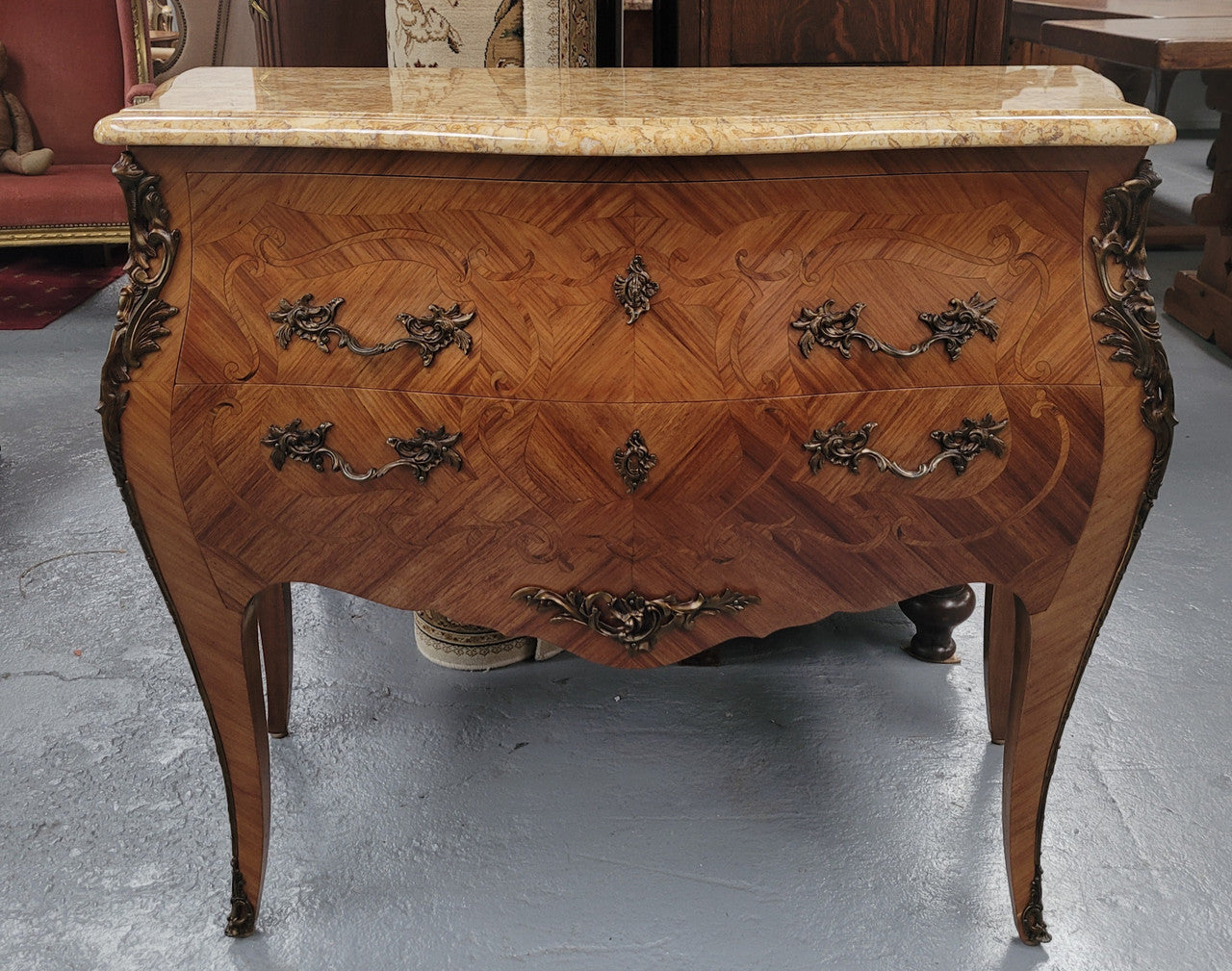 An elegant French Louis XV style kingwood two drawer commode with beautiful decorative inlay and ormolu mounts. Stunning coloured marble top and is in good original detailed condition.