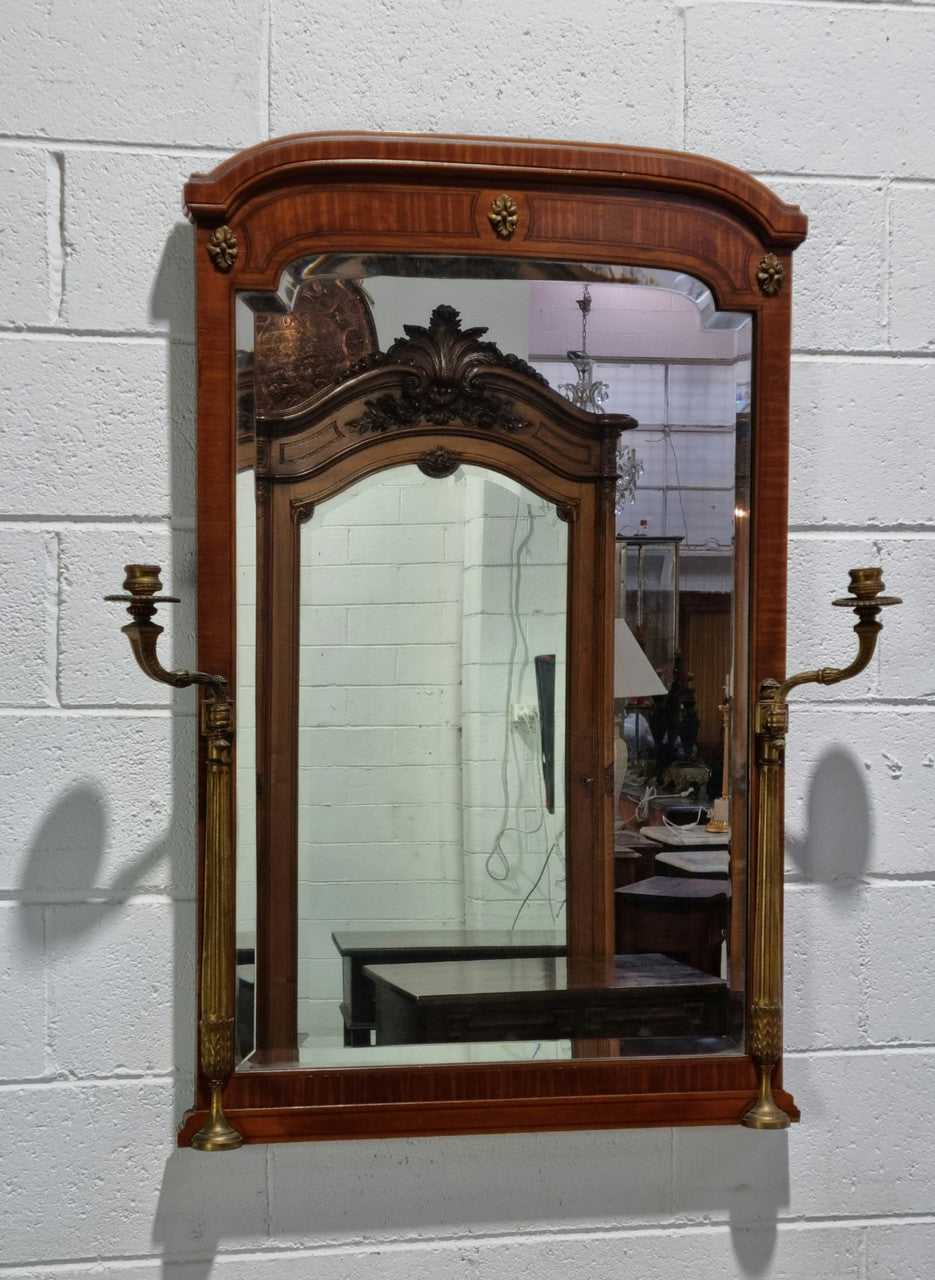 Decorative late 19th Century mahogany French wall mirror with brass swivel candle holders and brass detail. In good original detailed condition.