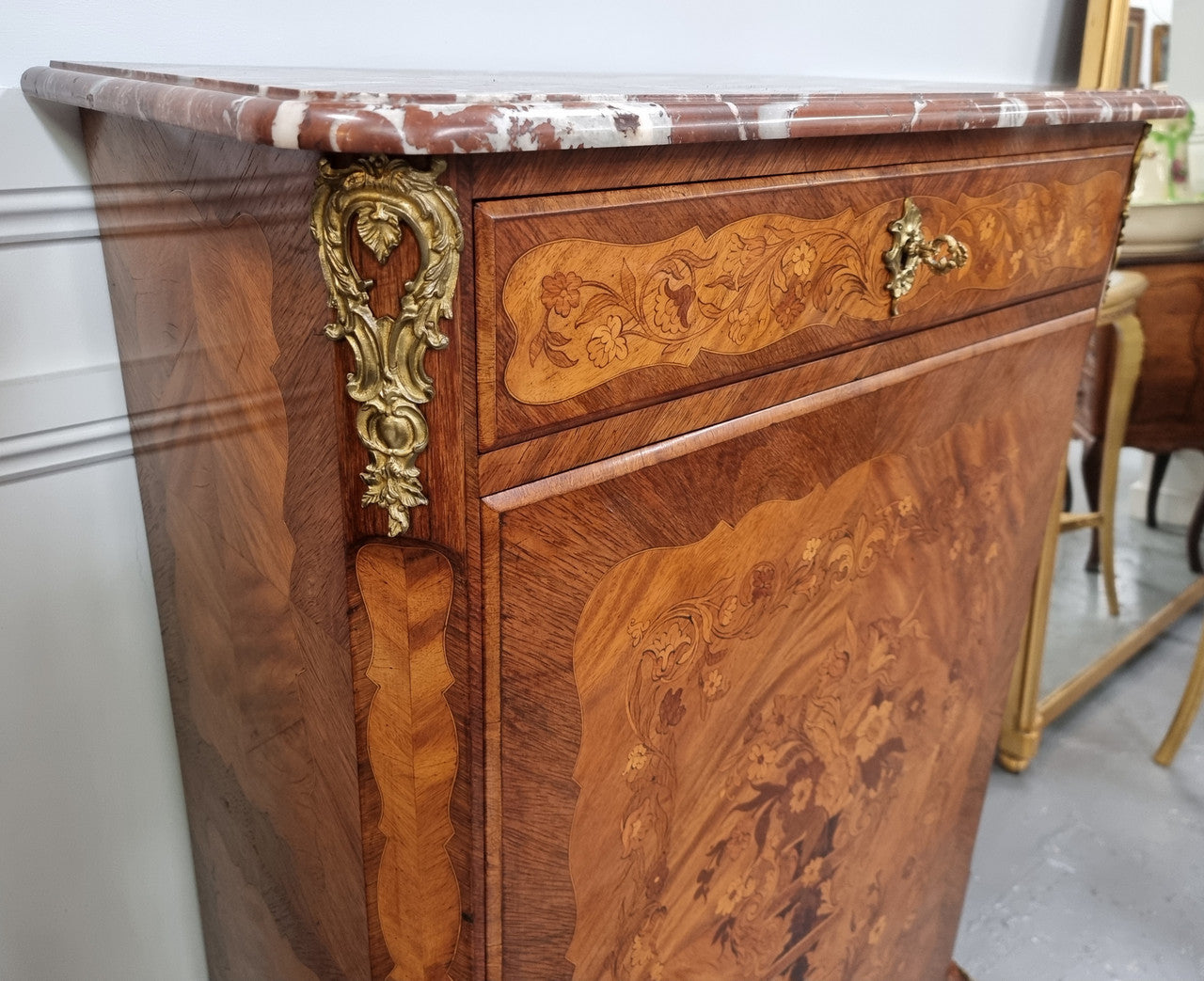Elegant French transitional style Walnut & Kingwood Salon cabinet. It has beautiful marquetry inlay, a marble top and decorative ormolu mounts. Sourced From France and is in good original detailed condition.