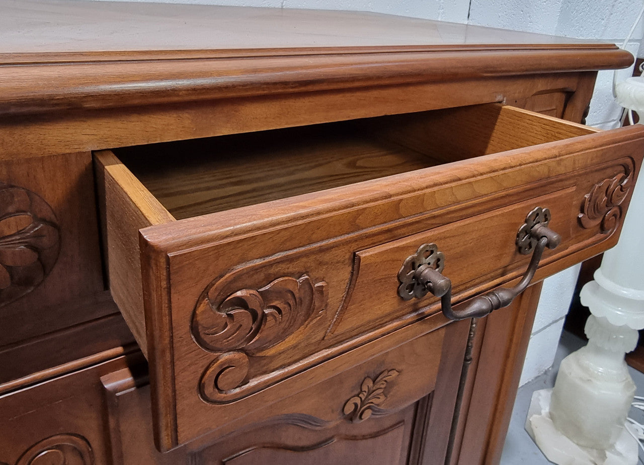 French Walnut two door buffet with parquetry top. It has two drawers and an adjustable shelf. In good original detailed condition and it has been sourced from France.