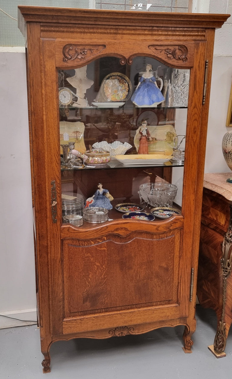 French Oak Louis XV Style Vitrine with two fixed glass shelves at the top and two fixed wooden shelves at the base for added storage. It has been sourced from France and in good original detailed condition.