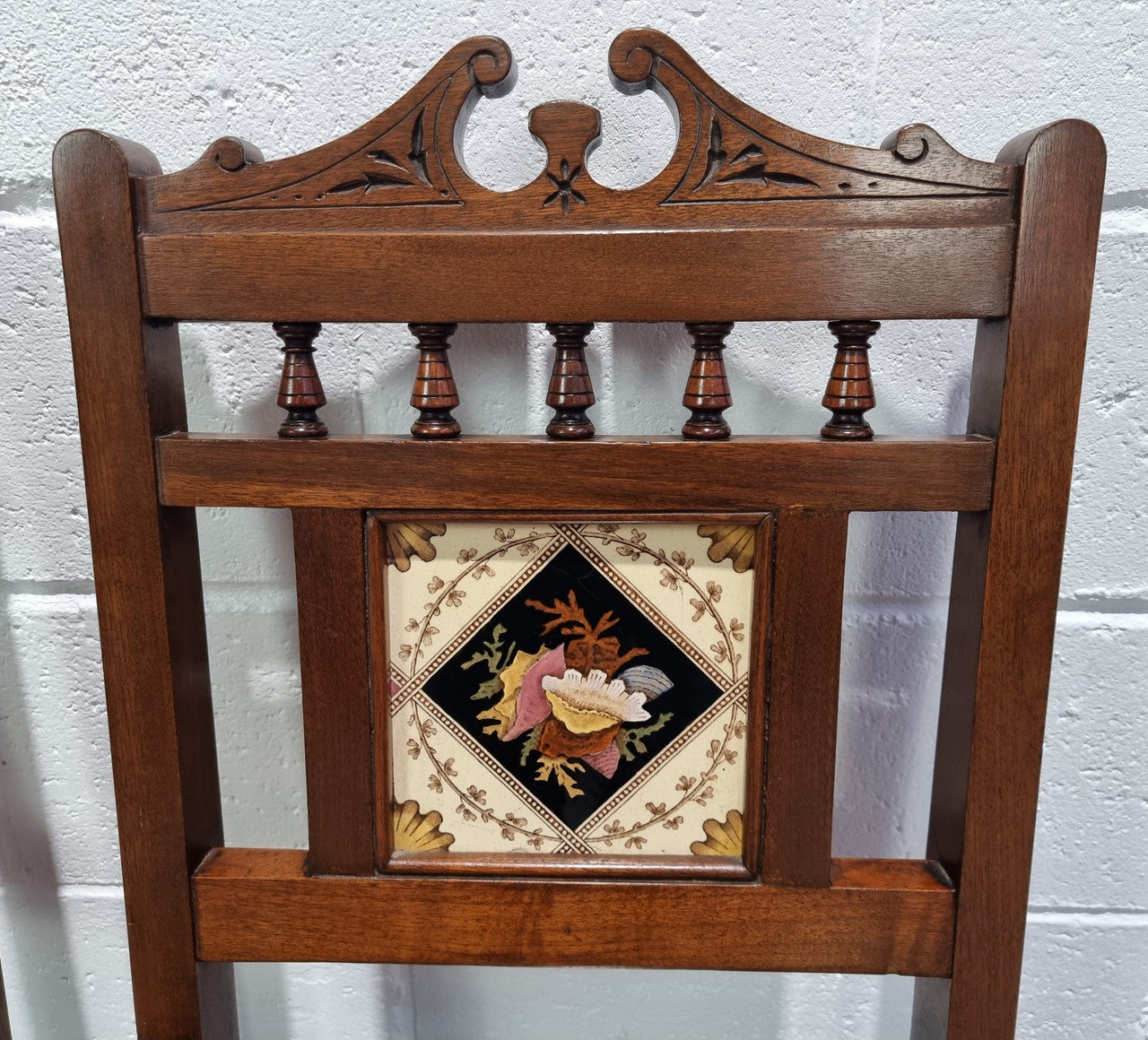 Pair of Edwardian Mahogany hall chairs with original tile in back. They are in very good original detailed condition.