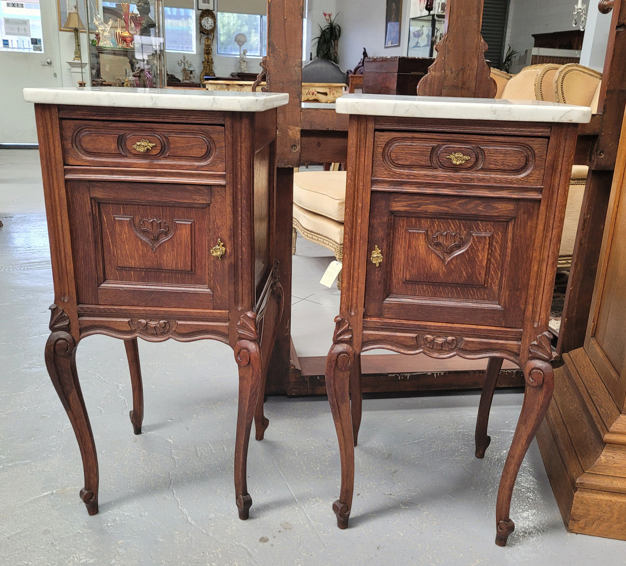Pair French oak Louis XV style white carrera marble top bedside cabinets. Consisting of one drawer and one cupboard each on elegant legs. Circa: 1900's