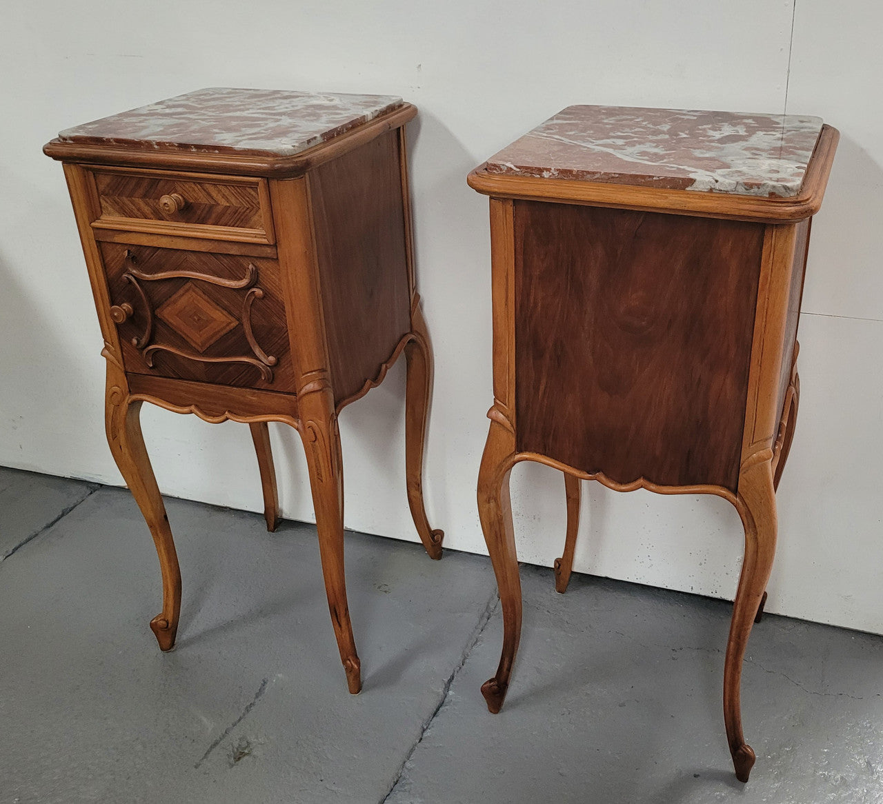 Pair French Walnut Louis XV style Bedside Cabinets with inset rouge carrera marble tops and parquetry inlay. Consisting of one drawer and one cupboard on very elegant legs. Circa: 1900's.