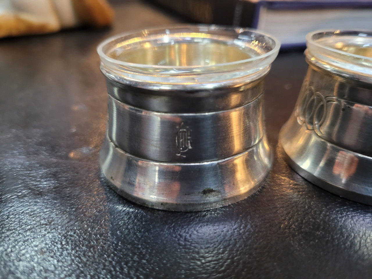 Pair antique silver salt cellars with liners. Stamped “800” 80g. 4.5cm Diam & 3cm Height. In good condition please view photos as they help form part of the description.