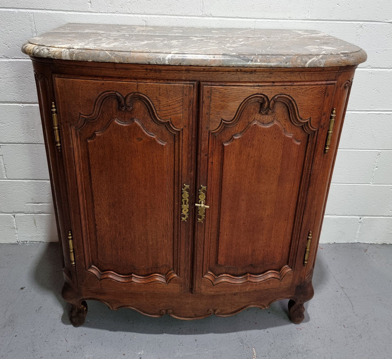 Rare 19th Century French Oak and marble top oval buffet / cabinet. Stunning thick marble top and decorative handles. In good original detailed condition.