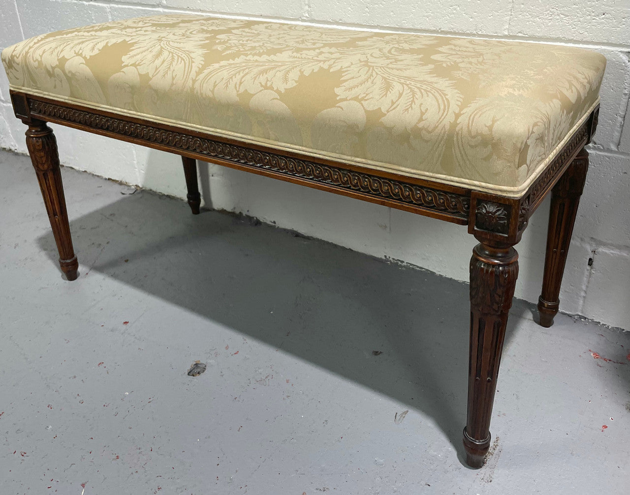 Nicely carved French Louis XVI style Walnut upholstered stool. The stool is in good condition and the frabic is in good used condition, please view photos as they help form part of the description.